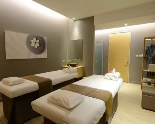 Serene and modern couple's massage room at Let's Relax Spa in Trang, Thailand, featuring two clean massage beds, perfect for a private spa treatment experience.