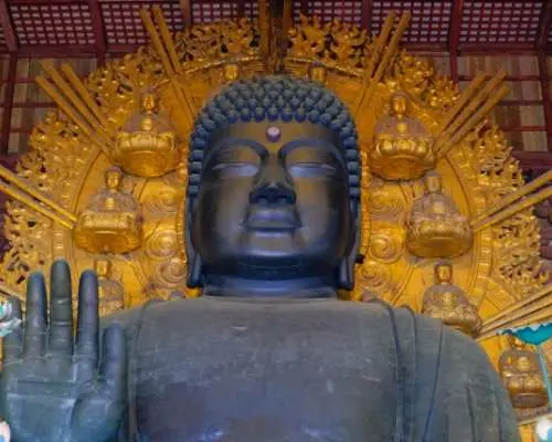 Close-up of the colossal Great Buddha statue inside Nara's Todai-ji Temple, revealing its sacred details and symbolizing Japanese cultural history.
