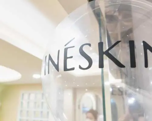 Close-up of the INESKIN brand logo on a clear balloon at the Mong Kok beauty center, highlighting details of their professional skin management and aromatherapy treatments.