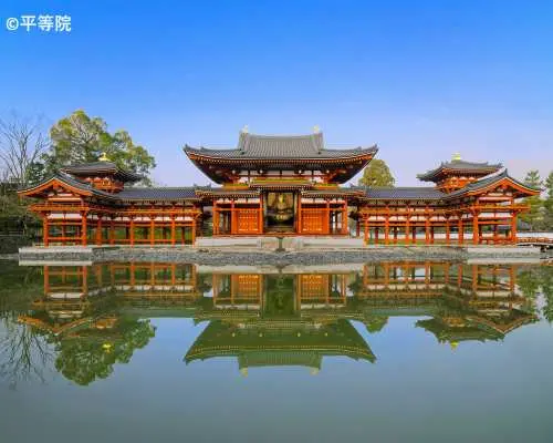 The magnificent UNESCO World Heritage Byodoin Phoenix Hall in Uji, Kyoto, with its grand architecture perfectly reflected in the calm waters, showcasing classical Japanese aesthetics.
