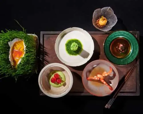 Close-up of Beijing Palace Banquet's exquisite cuisine, featuring multiple artfully plated imperial dishes that highlight the luxurious sensory experience of the royal feast.