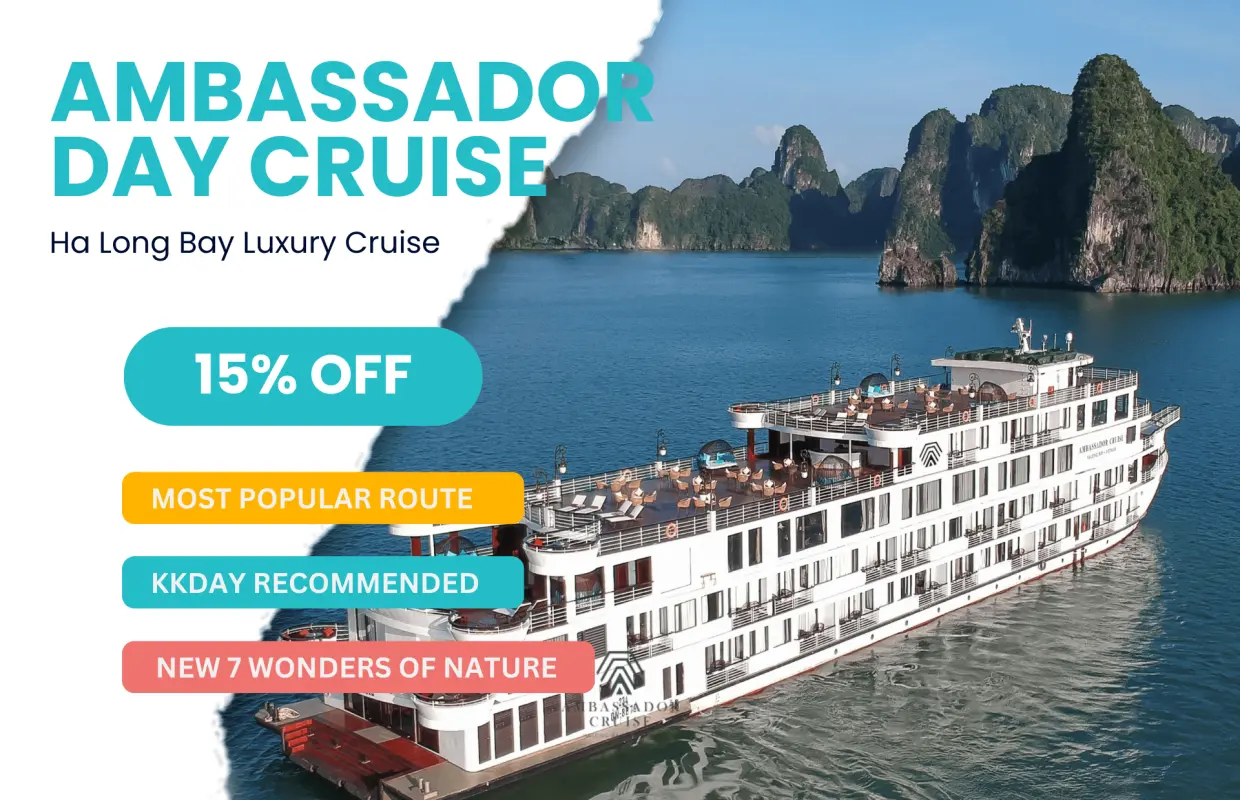 Ambassador luxury 5-star day cruise sailing through Halong Bay, showcasing its grandeur with limestone karsts and special promotional offers.