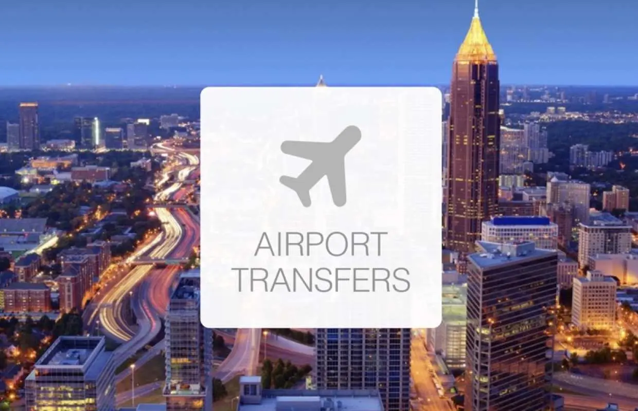 Atlanta city skyline at night with 'AIRPORT TRANSFERS' overlay, symbolizing private car service by a Chinese-speaking driver from the airport to downtown hotels.