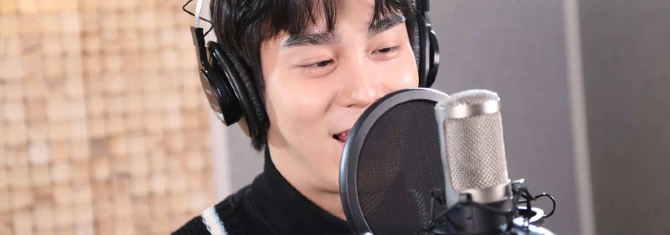 ソウル江南のHEMA STUDIOで、ヘッドホンを着用した男性がK-POP曲やKドラマOSTをプロのスタジオで楽しく録音する様子。