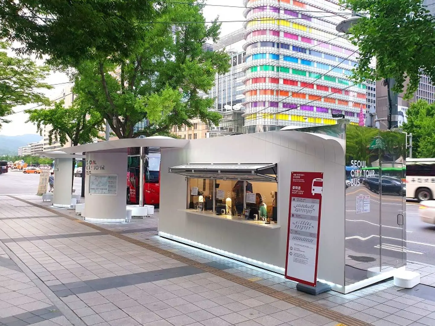 Modern white Gwanghwamun ticket counter for the Seoul City Tour Bus, where travelers collect or purchase tickets before embarking on their night view adventure.