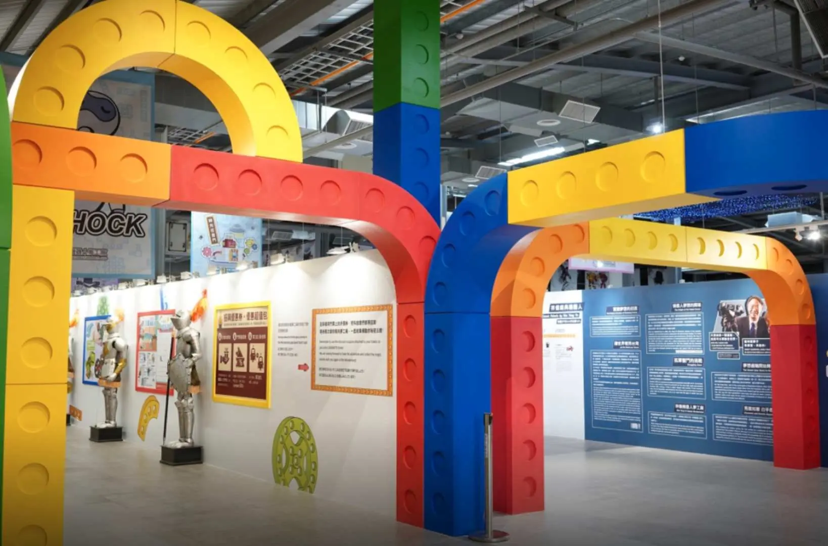 Taoyuan Xiangyi Robot Dream Factory, with colorful building block-shaped pathways guiding visitors through an exhibition hall featuring robot models and science display panels, creating an interactive learning atmosphere.
