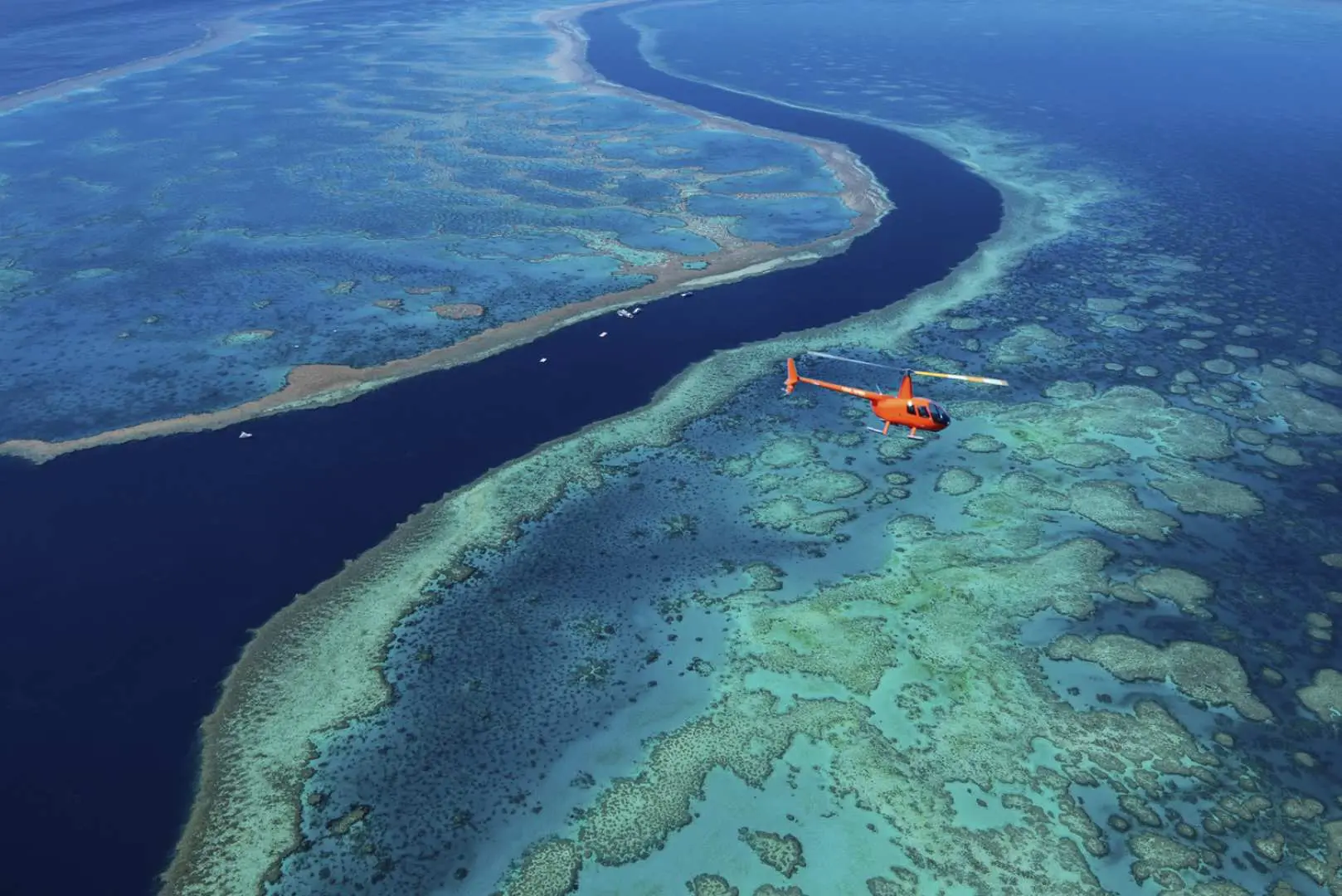 aerial view of helicopter and the great barrier reef below