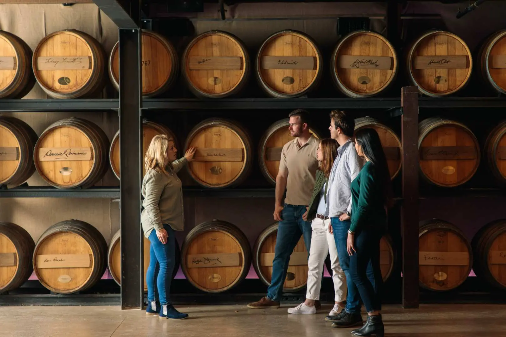 tour guide sharing information about set of casks of wine