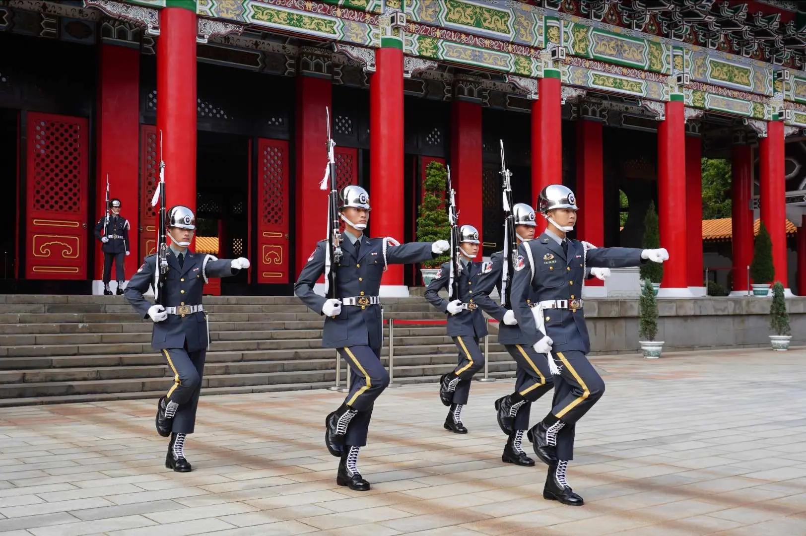 台北忠烈祠或中正紀念堂的衛兵交接儀式，儀隊士兵身著制服，步伐整齊，展現莊嚴的軍事文化景觀。