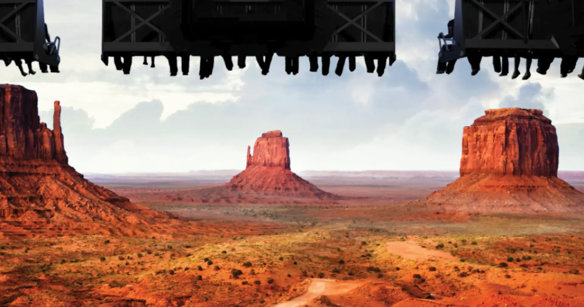 Immersive aerial perspective from FlyOver Las Vegas flying theater, showcasing the majestic American Wild West desert landscape with iconic red rock formations and vast canyons.