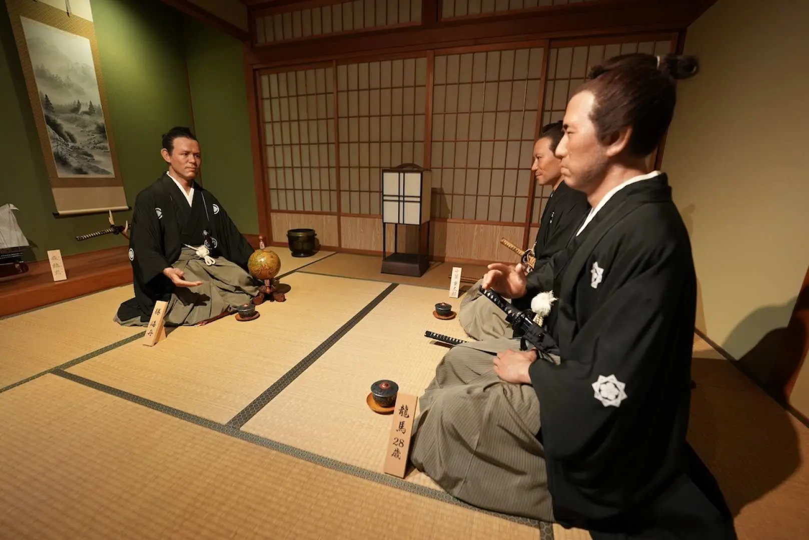 Inside Kochi's Ryoma History Museum, lifelike wax figures of Ryoma Sakamoto and companions recreate a traditional samurai era tea ceremony scene.