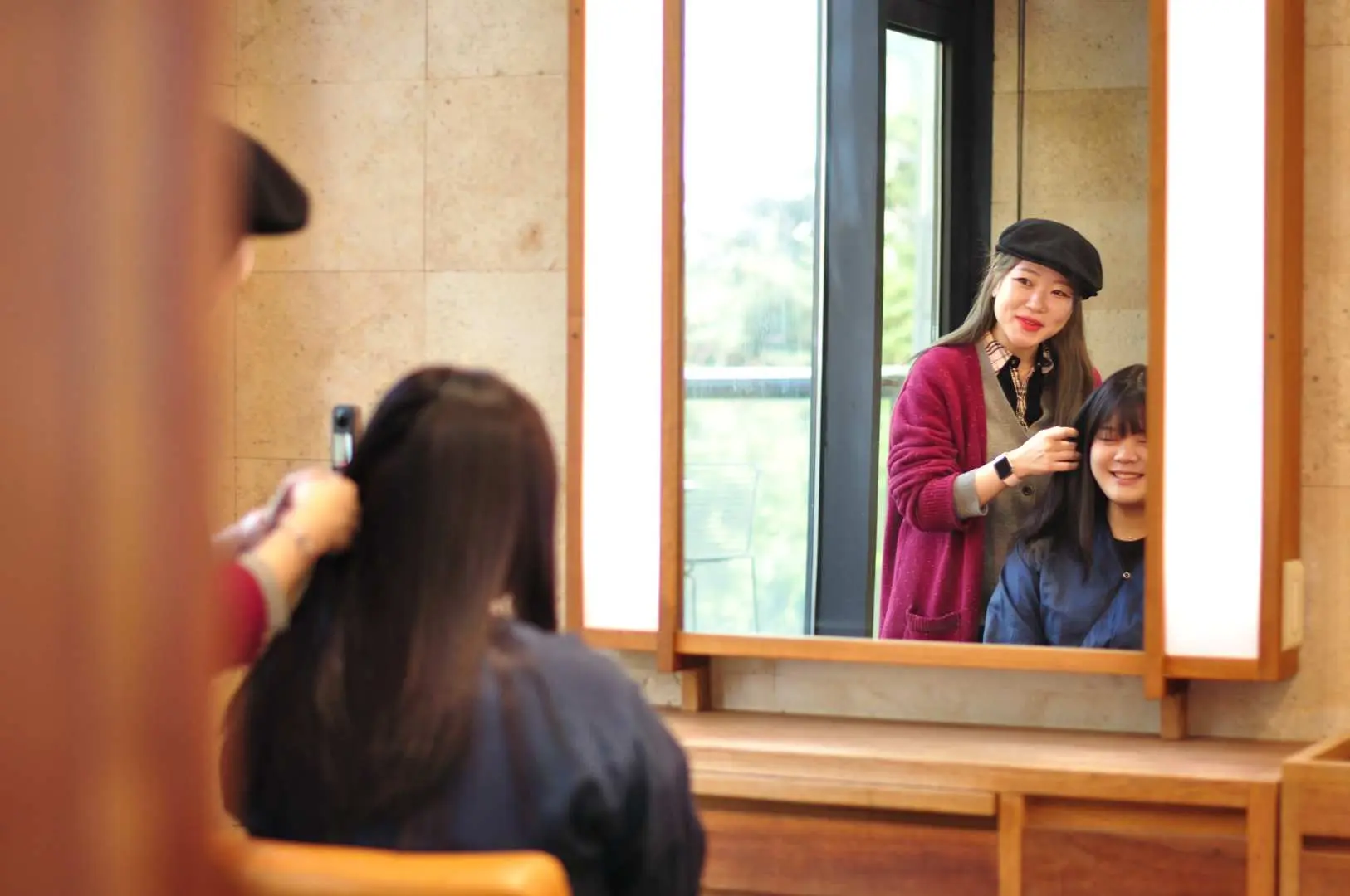 Hair stylist providing professional consultation for cutting, perming, or Korean styling at CARADI Seoul Gangnam luxury hair salon.