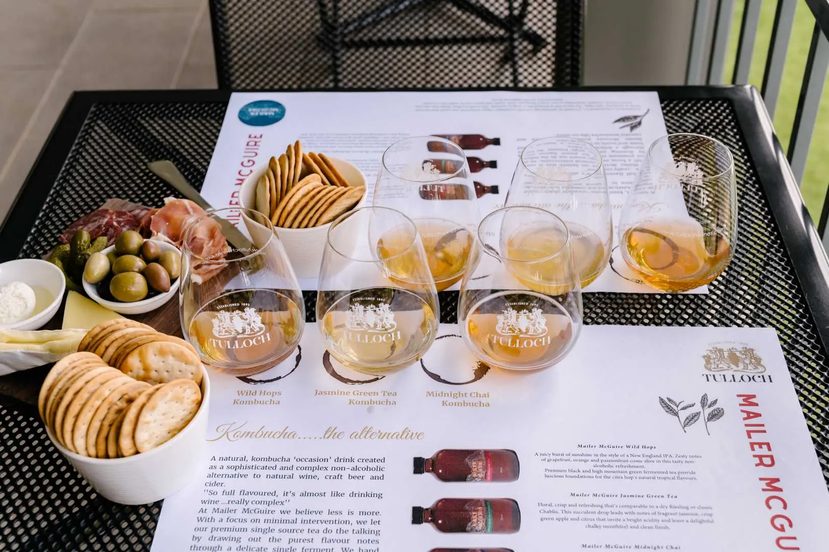 Hunter Valley Tulloch Wines' wine tasting pairing, with a table laden with cheese, olives, crackers, and selected meats, offering a rich experience of gourmet accompaniments.