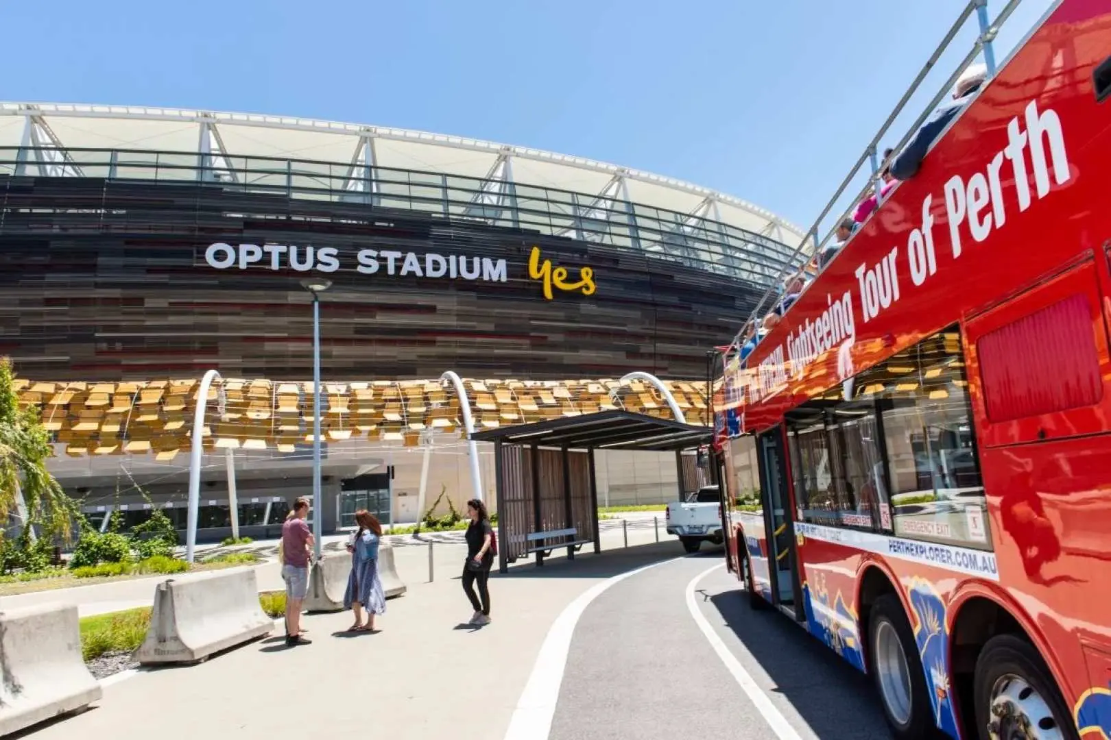 The Perth hop-on hop-off sightseeing bus stopped outside the impressive Optus Stadium, offering convenient access for visitors to explore this major sporting landmark.