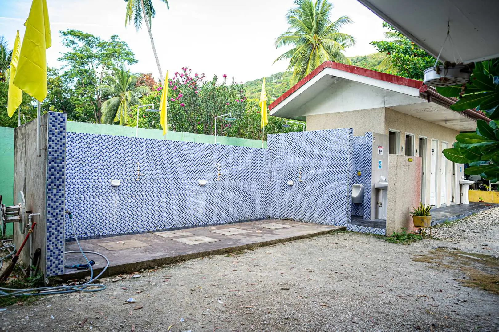 Clean and convenient outdoor shower and changing facilities with blue patterned tiles provided for guests at the Oslob tour stop in Cebu.
