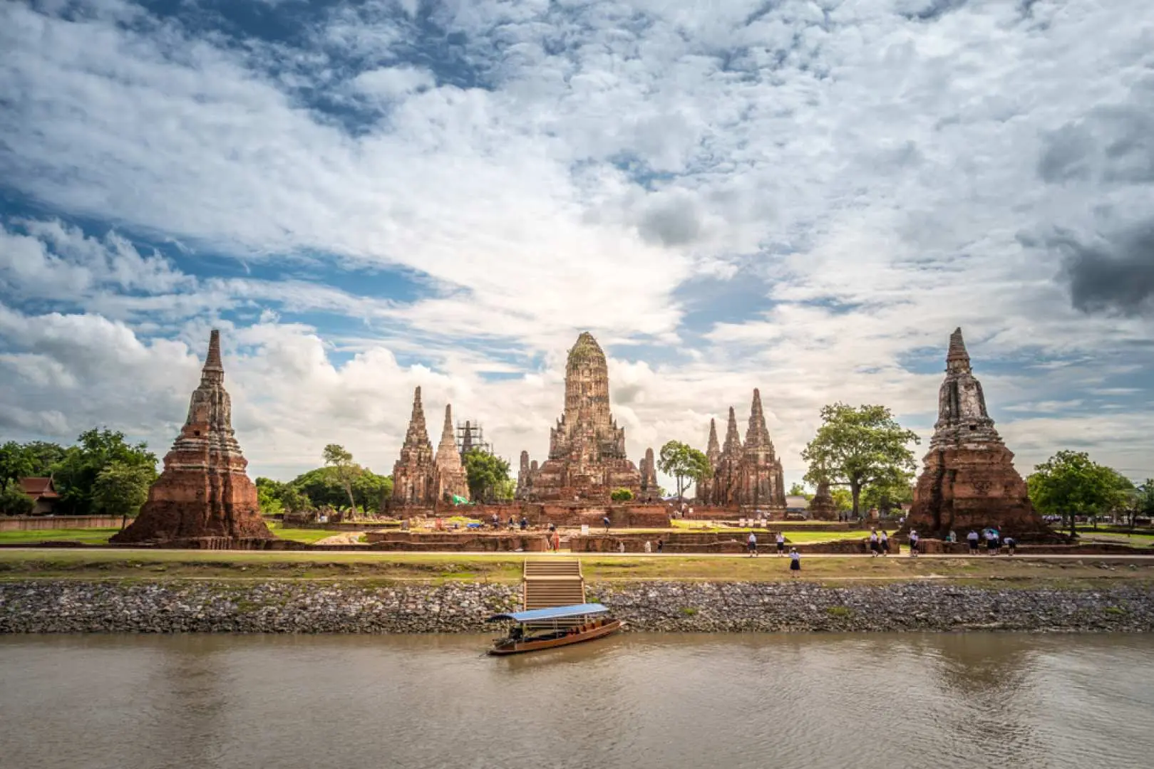 The majestic temple ruins of Wat Chaiwatthanaram in Ayutthaya, situated by the river, offering a magnificent view perfect for a longtail boat tour.