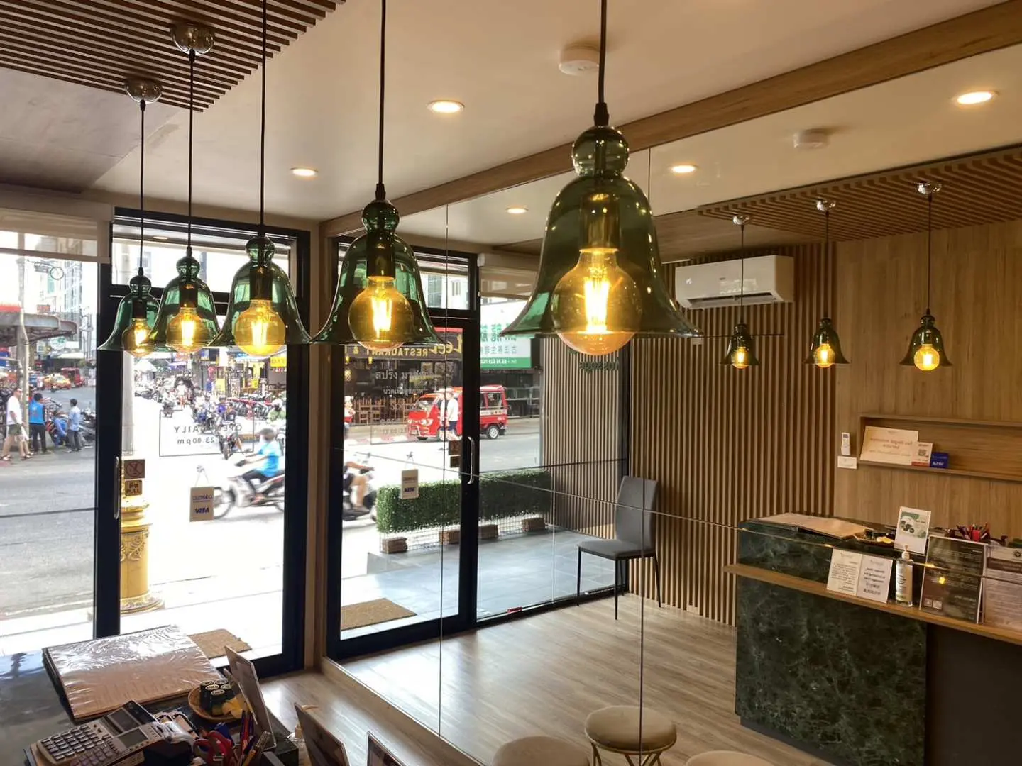 The spacious and bright reception area of Spring Massage Patong branch in Phuket, blending modern design with Thai wooden elements, offering a comfortable waiting space.