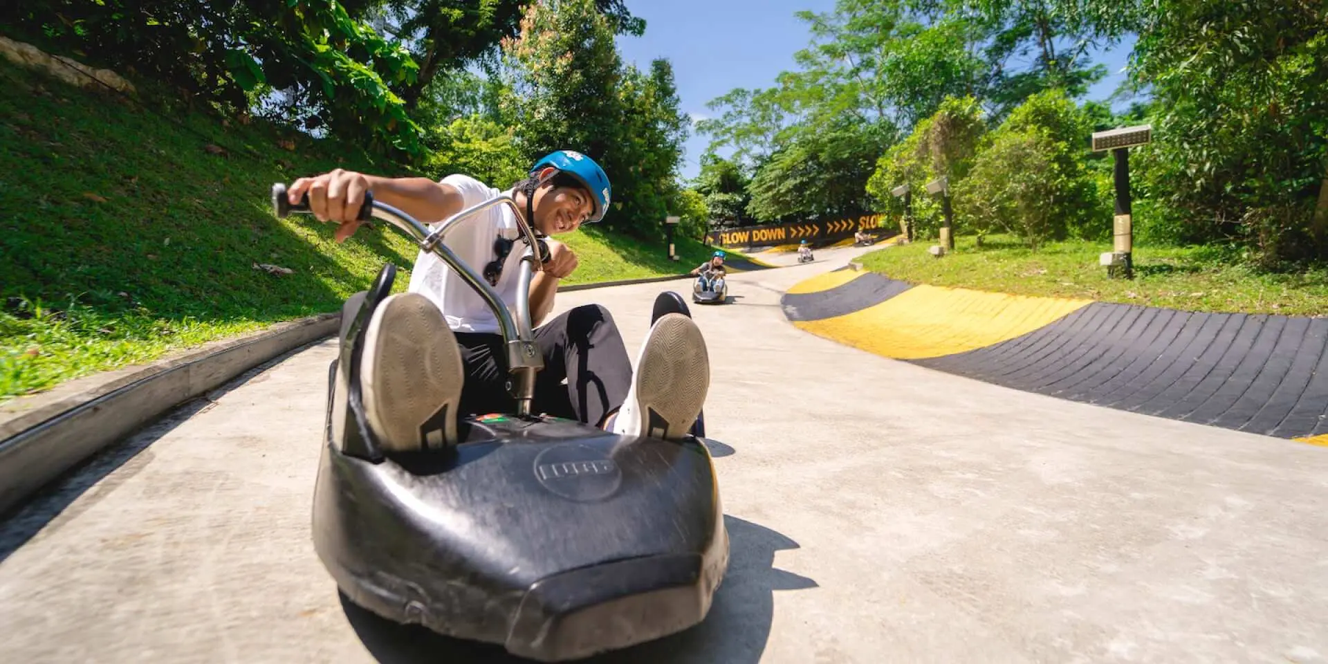 A man expertly navigates a hairpin bend on the luge track at Kuala Lumpur Skyline Luge, Malaysia, showcasing the thrilling challenges of the dedicated course.