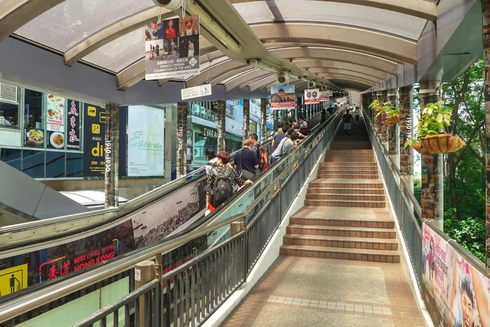 The Central-Mid-Levels Escalator in Hong Kong, with people commuting, offering a unique urban transport experience and a glimpse into daily life in Old Town Central.