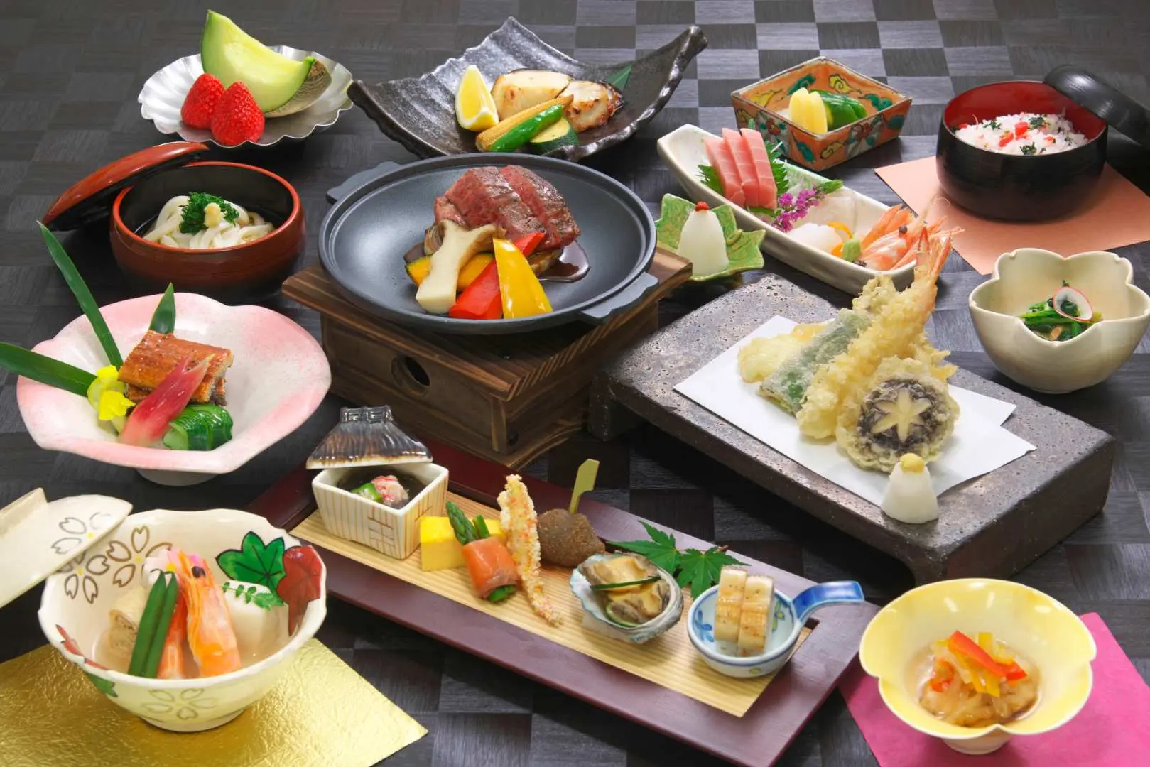 This luxurious kaiseki meal begins with seasonal appetizers, followed by fish dishes and Wagyu beef steak on a ceramic platter, all made with the finest ingredients.