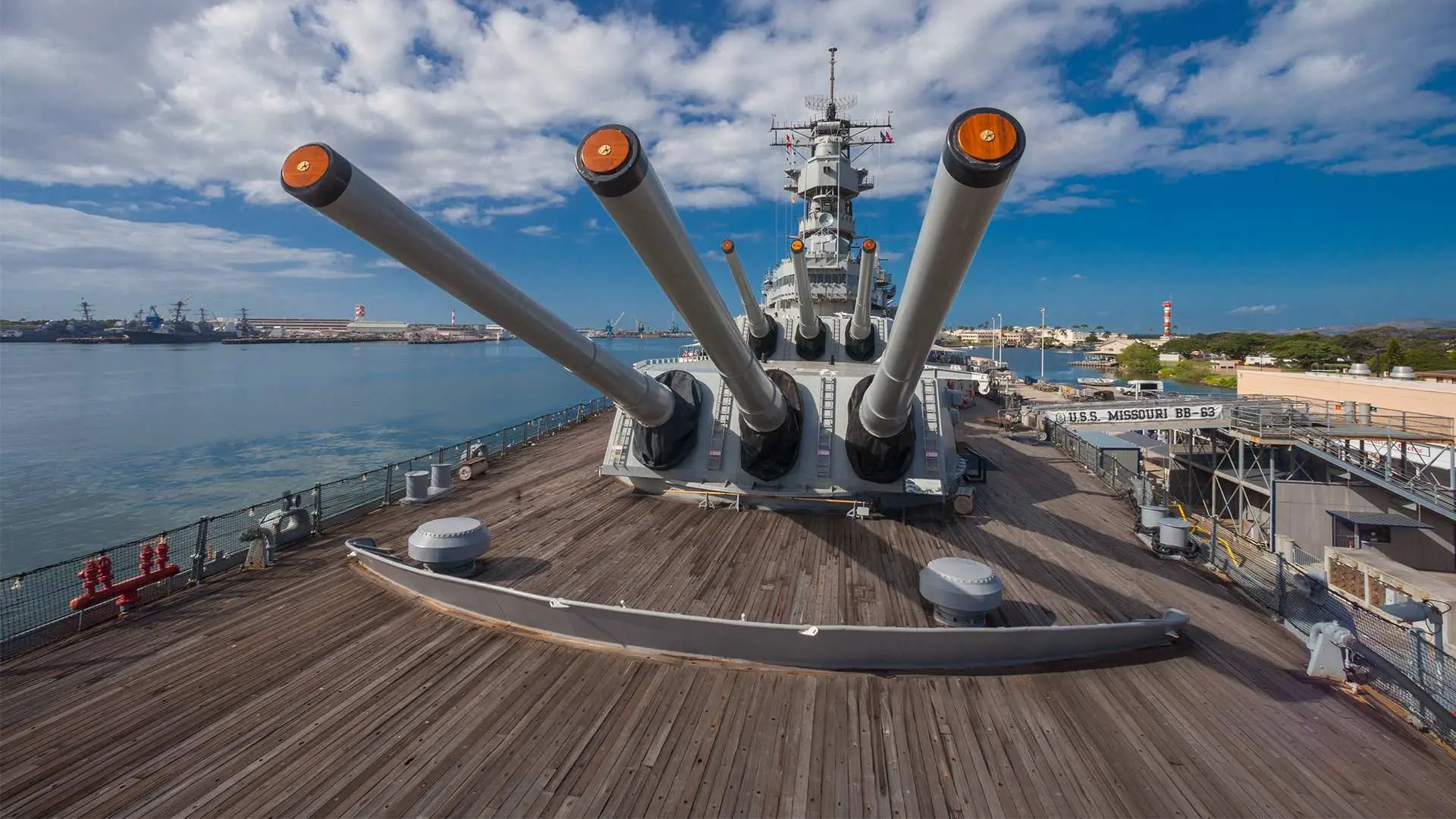 The Battleship Missouri Memorial at Pearl Harbor, Oahu, featuring the majestic ship deck and massive gun turrets, inviting visitors to explore significant historical footprints.