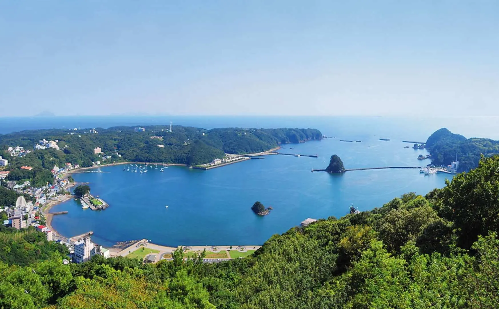 Panoramic view of Shimoda Port from Negata-yama observation deck in Shizuoka, Izukyu-Shimoda, revealing the 'One of the Three Views of Izu' with blue ocean and green mountains.