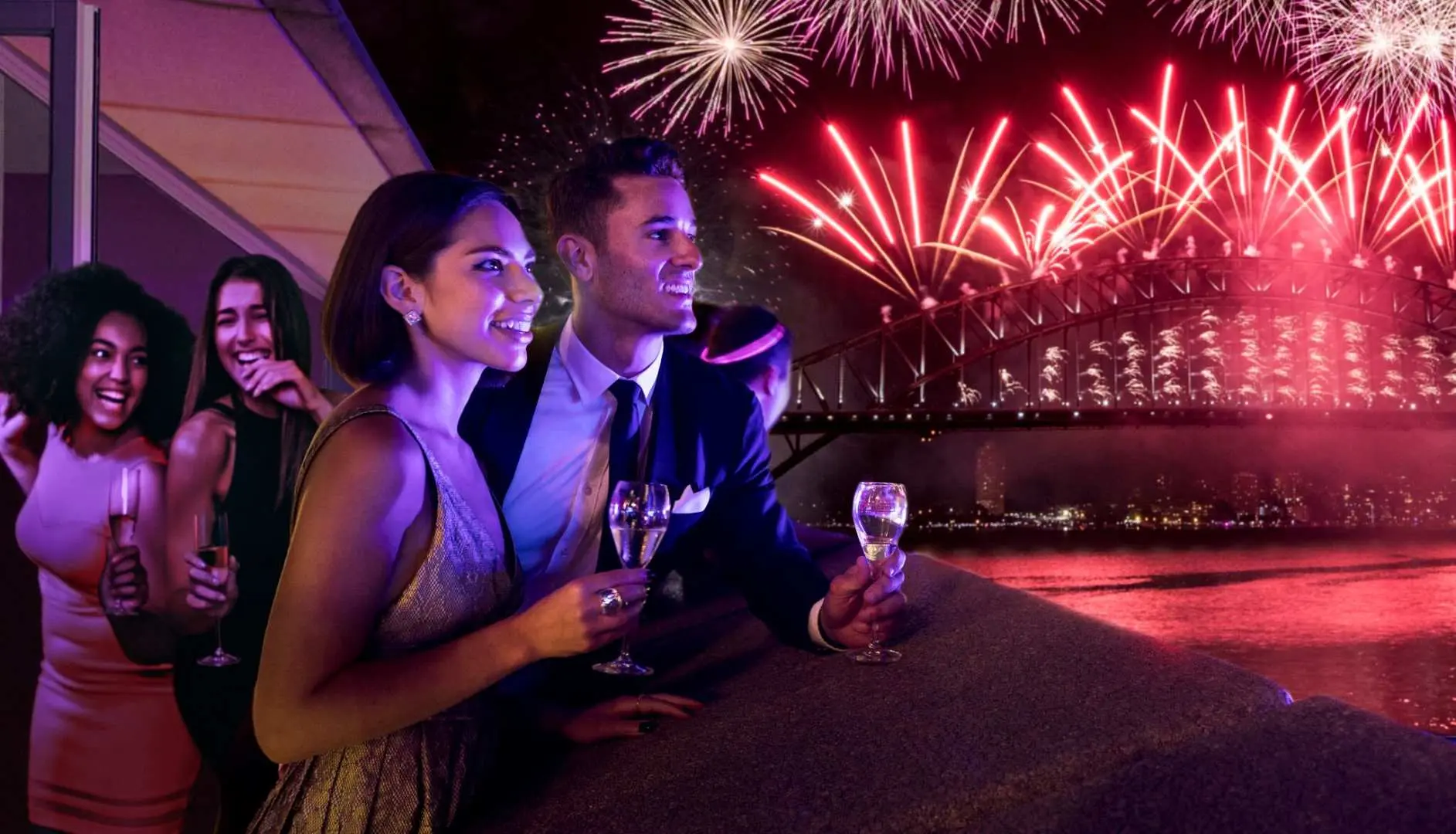 Couples and friends enjoying a New Year's Eve party overlooking Sydney Harbour, with vibrant red fireworks exploding over the iconic Sydney Harbour Bridge.