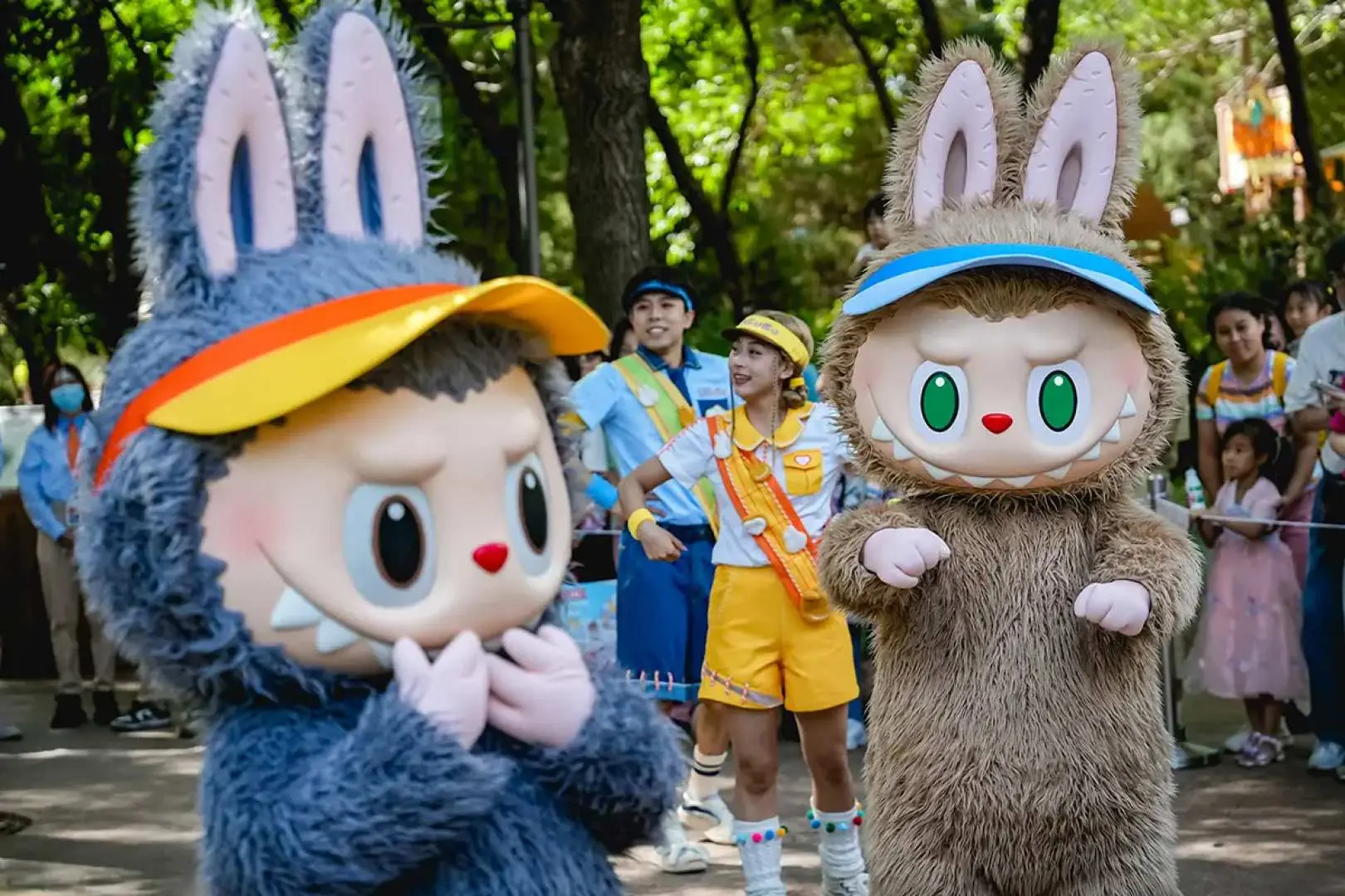 Two adorable bunny characters interact playfully with visitors in the forest area of Beijing POP MART CITY PARK, creating joyful photo opportunities.