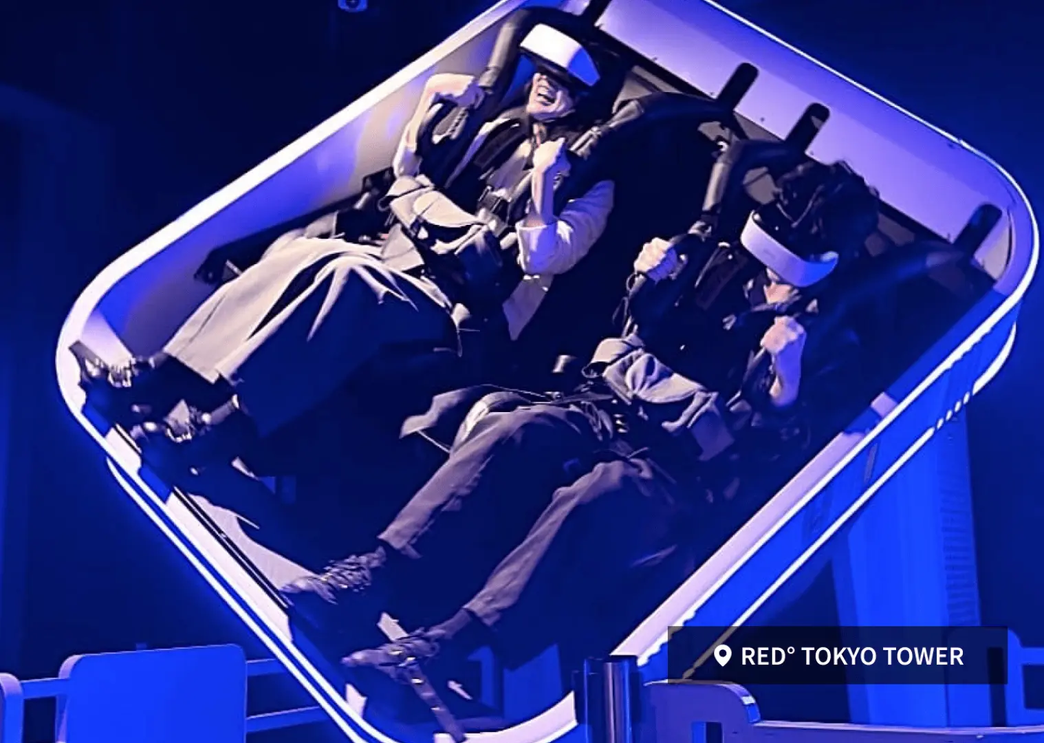 Two visitors experiencing an immersive VR virtual reality game at RED TOKYO TOWER, wearing headsets and enjoying thrilling interactive entertainment, exploring new Tokyo attractions.