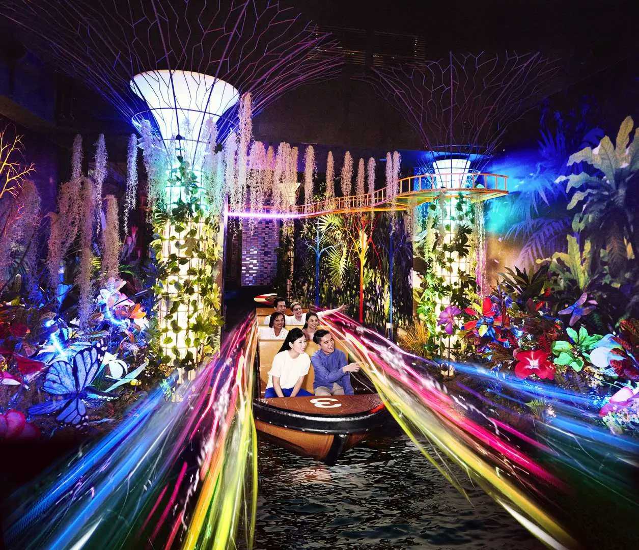 Visitors enjoying the 'Spirit of Singapore Boat Ride' at Madame Tussauds Singapore, navigating through a dazzling indoor river illuminated by vibrant, fantastical light installations and lush flora for an immersive cultural journey.