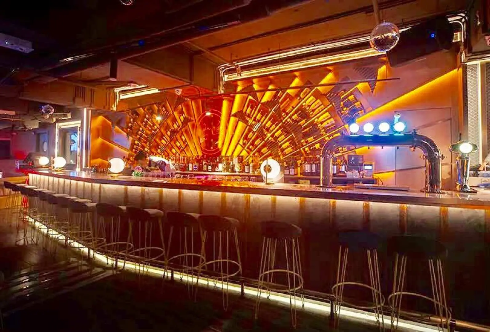 Spacious and stylish GULUGULU playful bar in Tsim Sha Tsui, showcasing its illuminated bar counter, unique decor, and lively atmosphere perfect for entertainment.