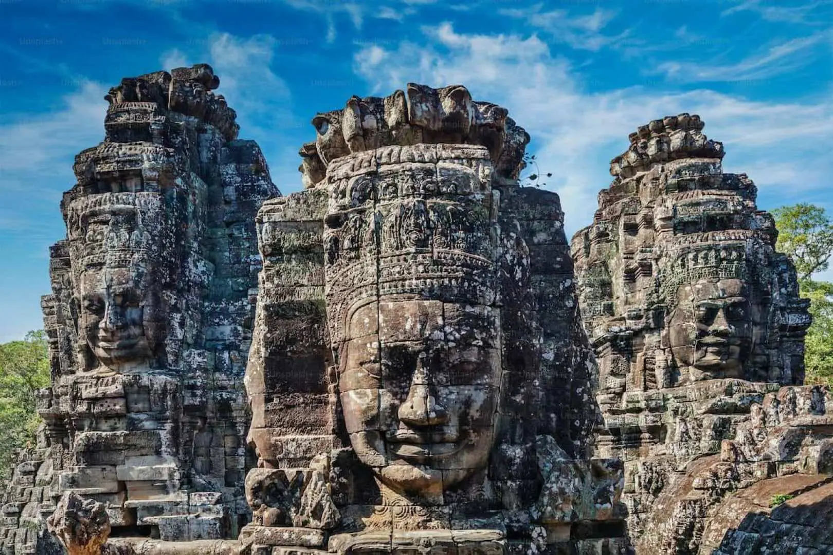 Close-up view of the iconic serene smiling stone faces carved into the towers of Bayon Temple, a highlight of Angkor Thom in Siem Reap.