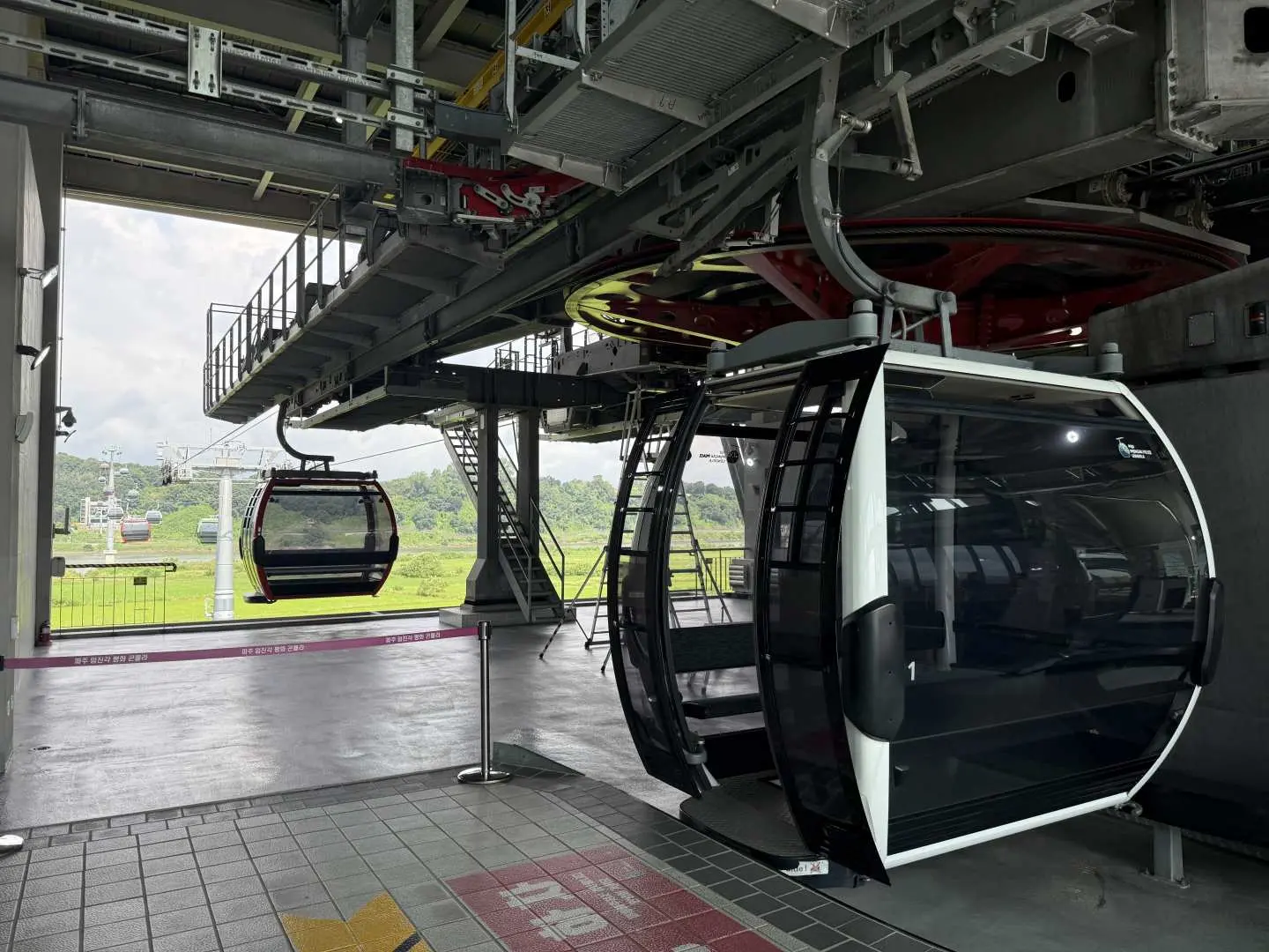 Modern cable car station with cabins docked and departing, offering travelers a convenient and scenic transportation option to reach Gimpo Aeghibong.