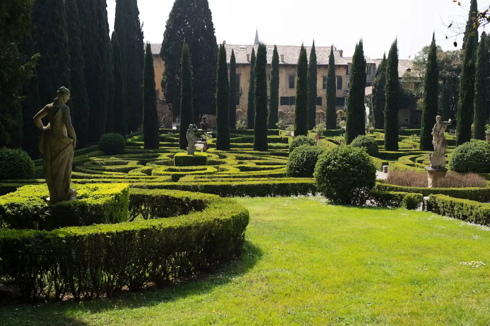 Classic beauty of Verona's Giusti Garden, featuring meticulously trimmed hedge labyrinths, elegant statues, and towering cypress trees, explore this peaceful oasis with the Verona Card.