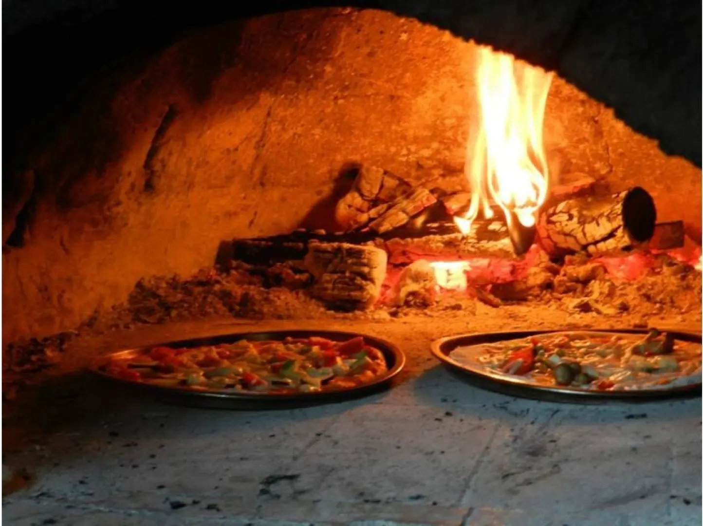 To the stone oven. It takes about 4 minutes to cook in the lava stone oven.