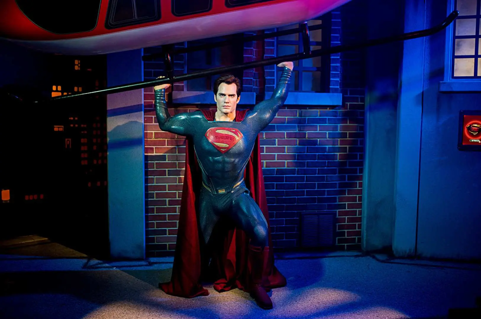 Superman's powerful wax figure at Madame Tussauds Sydney dramatically lifts a helicopter prop, offering visitors an exciting photo opportunity with the superhero.