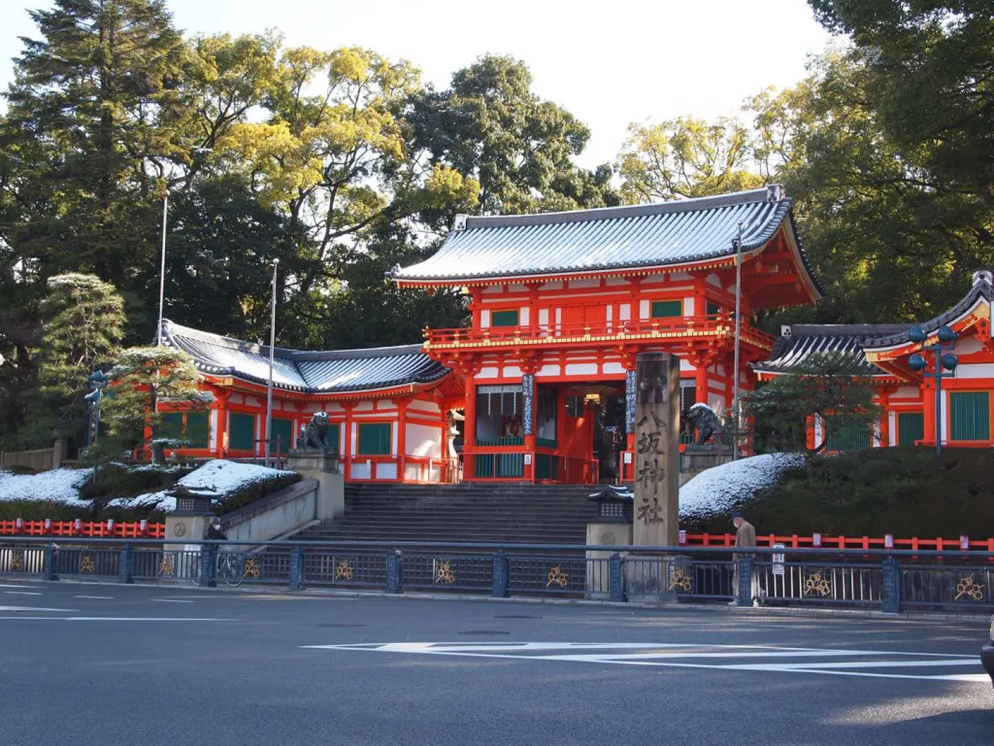 Kyoto's vibrant traditional red shrine with intricate details welcomes visitors up its stone steps, a famous historic site featured on the SKY BUS KYOTO tour.