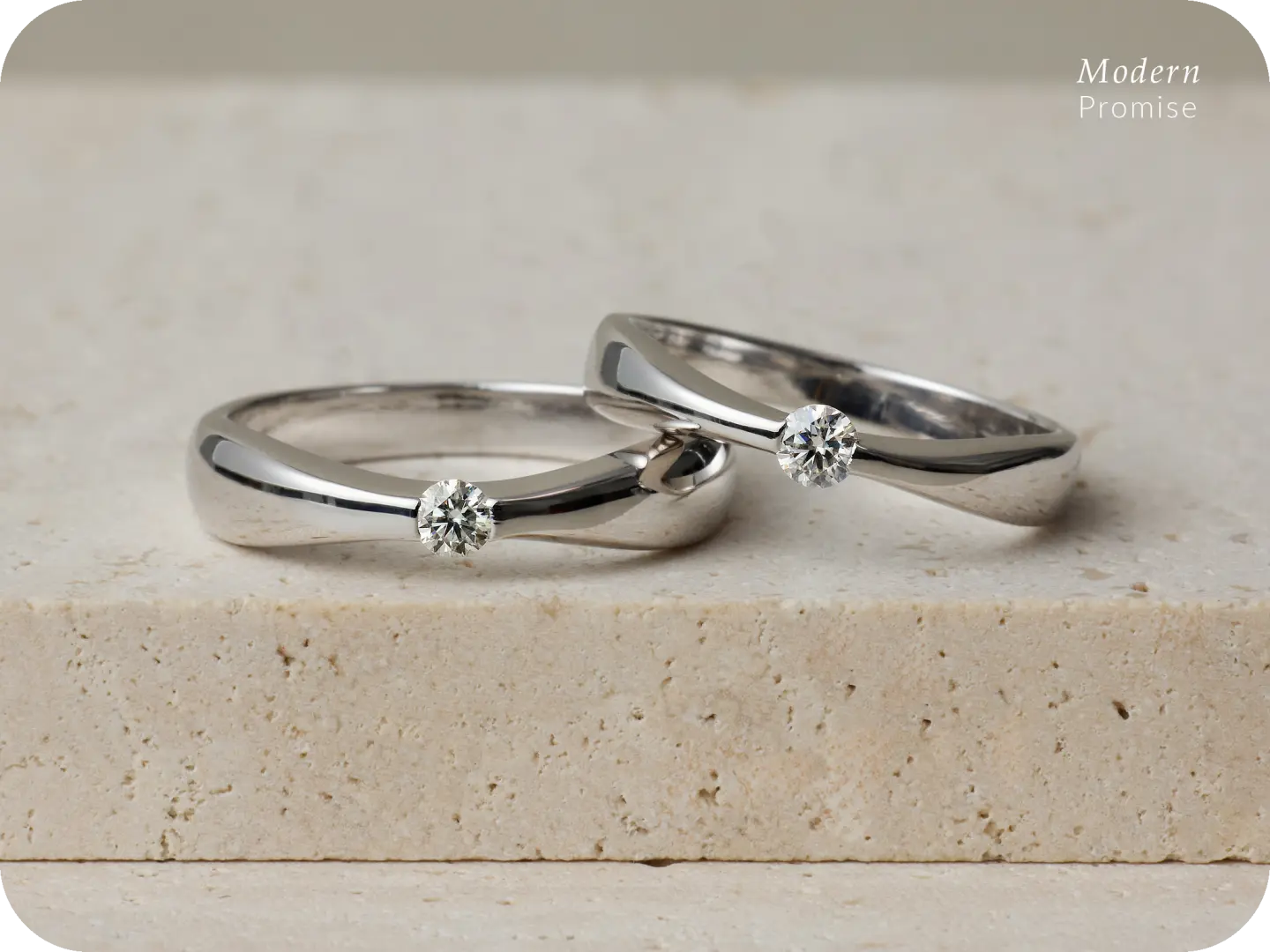 Exquisite finished products from Busan's DIY ring making workshop, two silver couple rings each adorned with a sparkling small diamond, symbolizing eternal love.