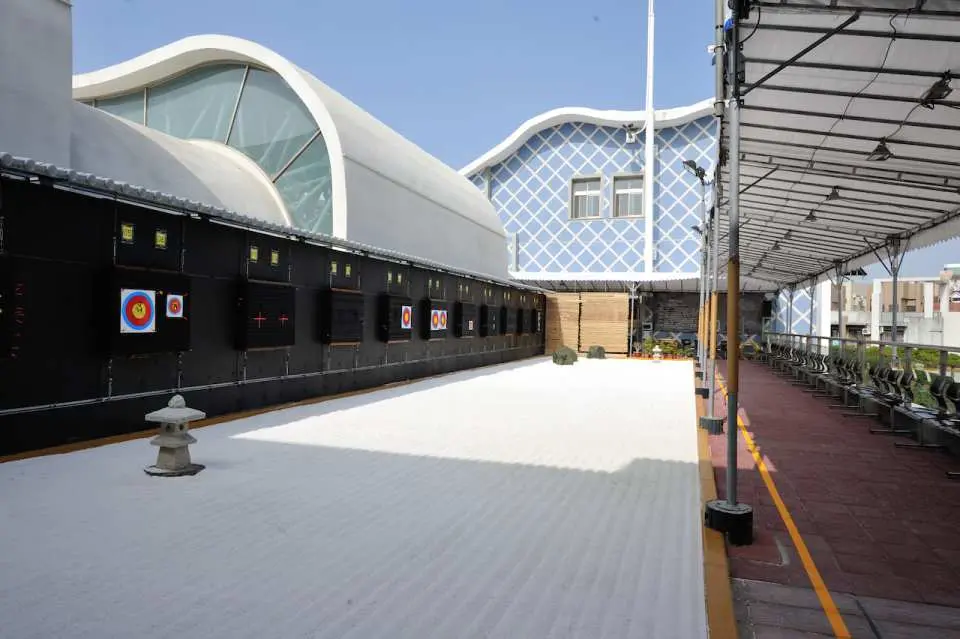The Zen dry landscape garden at Taichung's Enlightenment Archery Range, featuring multiple archery targets, an elegant stone lantern, and a modern architectural backdrop for a unique experience.