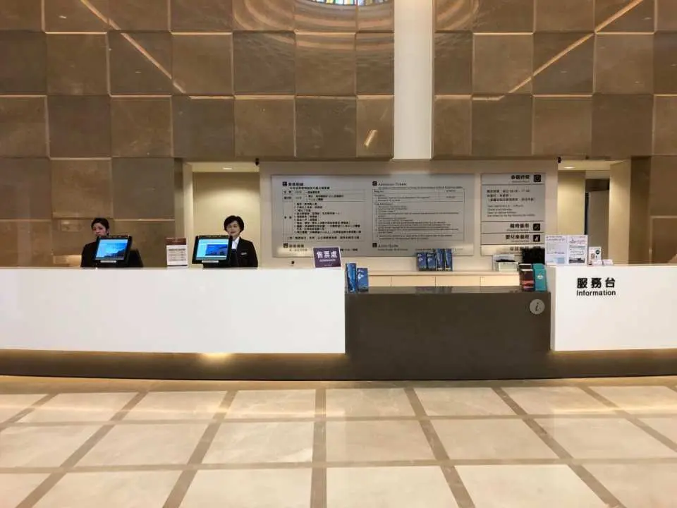 Spacious reception lobby of Chung Tai World Museum in Nantou, with friendly staff at the counter providing guidance and ticket exchange services, ensuring a smooth visitor experience.