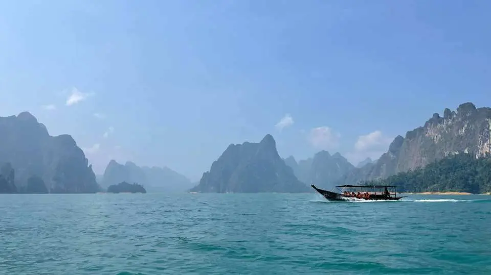 Aboard to a traditional long-tail boat upon arrival at the lake.