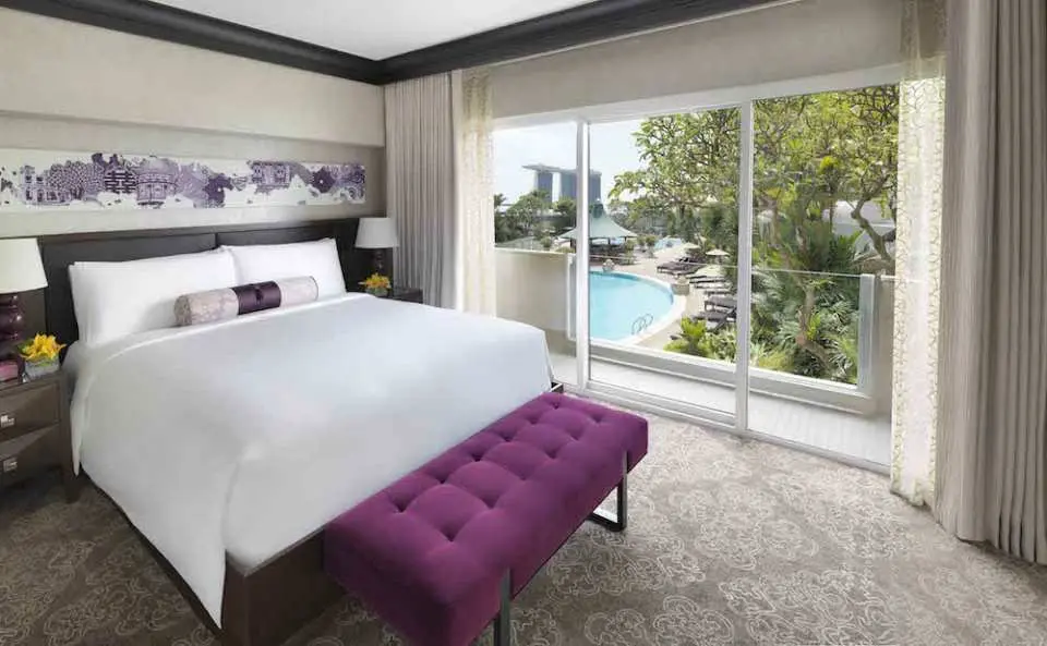 interior view of fairmont room with balcony and pool area in view outside