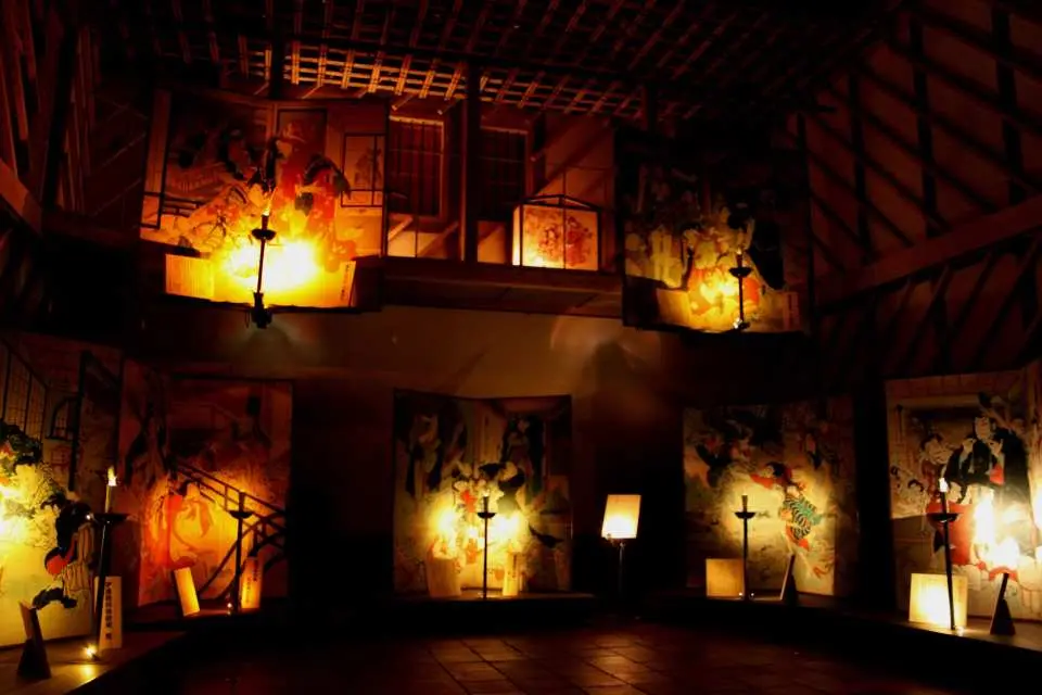 Darkened exhibition hall at Kochi, Japan's Ekin Museum, displaying legendary Ukiyo-e artworks by Hirose Kinzo under soft lighting, creating a unique artistic atmosphere.