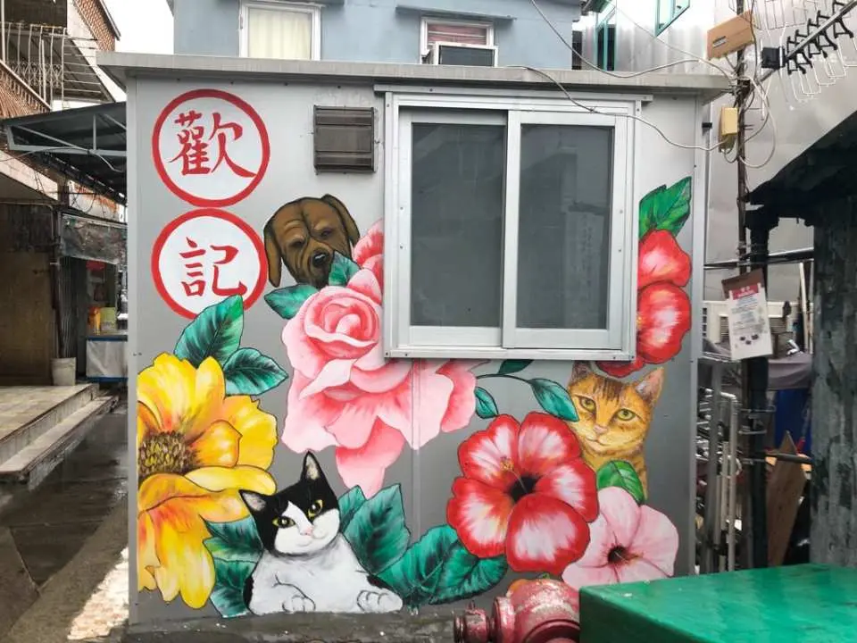 大澳街頭一面牆壁上，充滿童趣的壁畫描繪著可愛的貓狗和盛開的花朵，為漁村增添色彩。