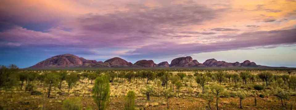 wide view of road, desert, and rolling rock formations of kata tjutua