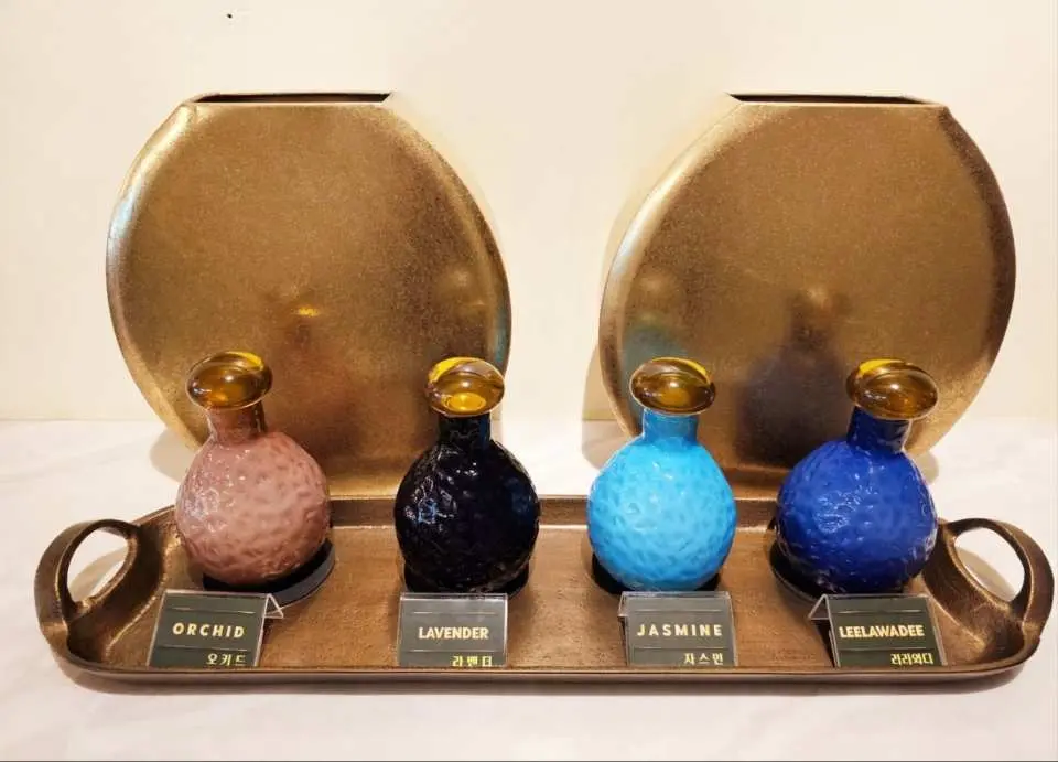 Manchai Spa Bangkok's extensive selection of aromatherapy essential oils, featuring four distinct scents like Orchid, Lavender, Jasmine, and Leelawadee, offering a personalized relaxing experience for aromatic spa massages.