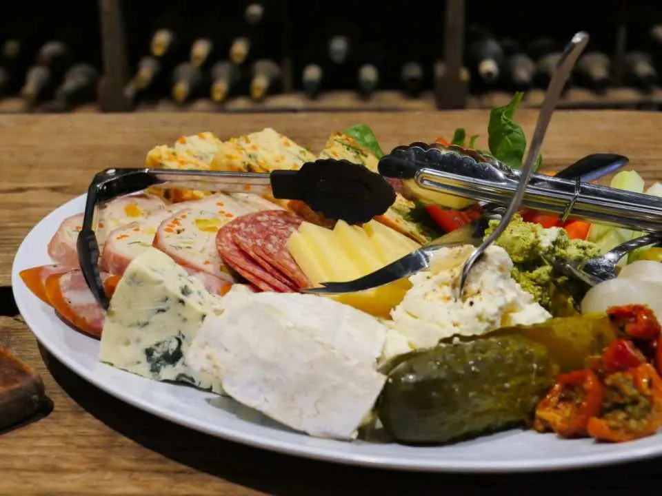 A generous produce platter featuring local cheeses, cured meats, and gourmet delights, perfect for pairing with fine wines during the Coonawarra Highlights Wine Tour in South Australia.