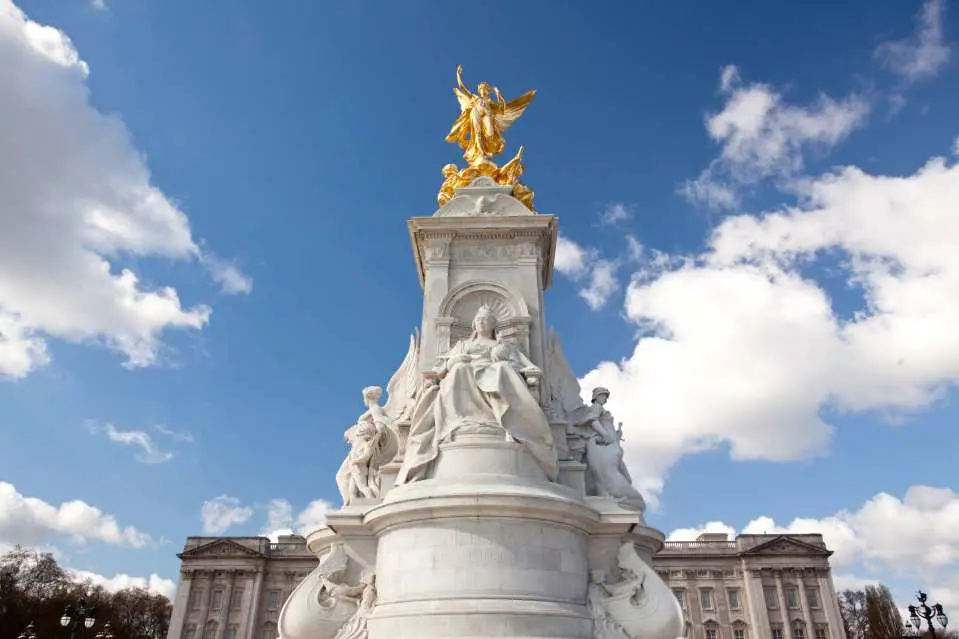 Strike a pose in front of Queen Victoria's statue outside the Palace gates