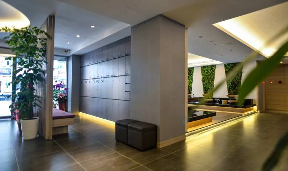 台北禾匯足體養生行館寬敞明亮的接待大廳，設有置物櫃與舒適休息區，提供顧客在享受24小時按摩服務前的放鬆空間。