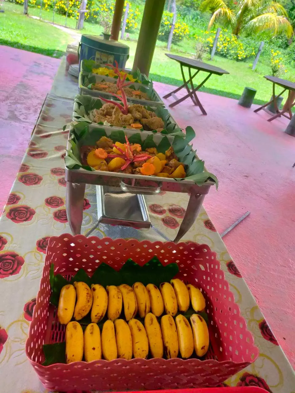 A lavish outdoor buffet lunch served after the Padas River whitewater rafting, featuring a variety of local delicacies and fresh fruits, providing essential replenishment for adventurers.